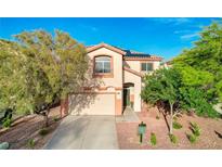 Two-story home featuring a two-car garage, desert landscaping, and a well-manicured front yard at 10988 Salernes St, Las Vegas, NV 89141