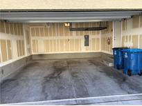 Spacious two car garage featuring concrete flooring, ample lighting, and storage shelving at 12112 Polar White Ct # 3, Las Vegas, NV 89183
