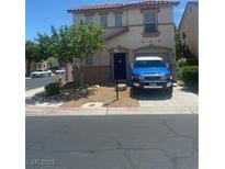 Charming two-story home with a well-manicured front yard and a parked SUV at 123 Gilliflower Ave, Las Vegas, NV 89183