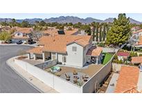 This backyard features a fire pit, lounge seating, an above ground pool, and mountain views at 2021 Summit Pointe Dr, Las Vegas, NV 89117