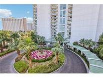 Luxury high-rise features a grand entrance, lush landscaping, and convenient covered parking at 222 Karen Ave # 3208, Las Vegas, NV 89109
