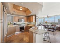 Modern kitchen featuring granite countertops, stainless steel appliances, and open layout to living area with great views at 222 Karen Ave # 3208, Las Vegas, NV 89109