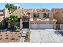 Charming two-story home featuring a tile roof and a well-maintained landscaped front yard at 2409 Alpine Meadows Ave, Henderson, NV 89074