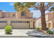 Charming home featuring a two-car garage, mature tree, and well-maintained landscaping at 3935 Tirana Way, Las Vegas, NV 89103