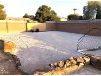 Spacious backyard featuring sand, block wall, rock borders, and a soccer net, ideal for recreational activities at 4011 Scott Russell Ct, North Las Vegas, NV 89031