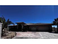 Spacious single-story home featuring an attached garage and desert landscaping at 4011 Scott Russell Ct, North Las Vegas, NV 89031
