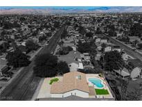 Expansive aerial view of a home showcasing a private pool and desert landscaping at 6330 Spring Meadow Dr, Las Vegas, NV 89103