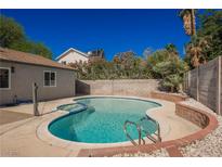 Beautiful backyard pool with lush greenery, hardscape, and privacy fencing at 6330 Spring Meadow Dr, Las Vegas, NV 89103