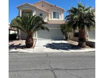 Charming two-story home featuring a two-car garage and desert landscaping at 7228 Chic Ave, Las Vegas, NV 89129