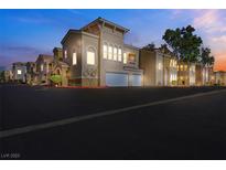 Charming two-story building with a two-car garage in a well-maintained community at dusk at 10001 Peace Way # 1250, Las Vegas, NV 89147