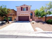 Charming two-story home with a well-maintained front yard and a two car garage at 10469 Mulvaney Cir, Las Vegas, NV 89141