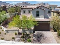 Charming two-story home with desert landscaping and a brick driveway set against a mountain backdrop at 11856 Barona Mesa Ave, Las Vegas, NV 89138