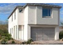 Modern two-story home with a gray garage door and white stucco exterior at 11881 Pied Harrier Ave, Las Vegas, NV 89138
