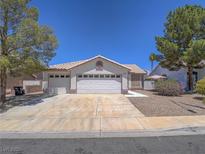 Charming single-story home with a three car garage, low maintenance landscaping, and a tile roof at 1424 Heartstring Ct, Henderson, NV 89002