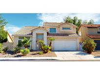 Charming two-story home featuring a tile roof, desert landscaping, and an attached two car garage at 1745 Walingwood Dr, North Las Vegas, NV 89031