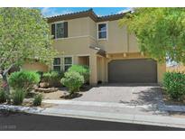 Inviting two-story home featuring a two-car garage and well-maintained front yard landscaping at 2117 Leatherbridge Ct, North Las Vegas, NV 89081