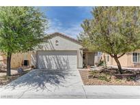Charming single-story home with a two-car garage and mature trees shading the front yard at 2304 Willow Wren Dr, North Las Vegas, NV 89084