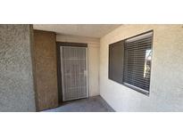 A secure front door with a security screen door and a window located to the right side at 3151 Soaring Gulls Dr # 1074, Las Vegas, NV 89128