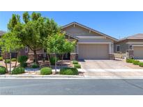 Charming single-story home with manicured landscaping and a brick driveway at 379 Mano Destra Ln, Henderson, NV 89011