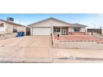 Modest single-story home with driveway, low fencing, and barred windows at 4386 El Cebra Way, Las Vegas, NV 89121