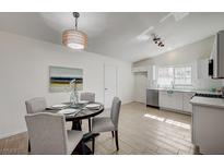 Eat-in kitchen features modern lighting, stainless steel appliances, and hardwood floors at 4496 Skyview Dr, Las Vegas, NV 89104