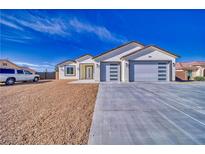 Charming single-story home boasting a two-car garage and desert landscaping, perfect for low maintenance at 4861 Ridgewood, Pahrump, NV 89061