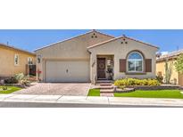 Inviting single-story home with a brick driveway, manicured lawn, and a charming front entrance at 489 Open Hill Ave, Henderson, NV 89011