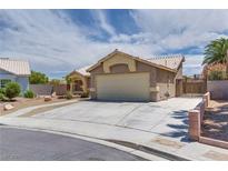 Charming one-story home with a two-car garage and a well-maintained front yard at 5116 Blue Onion Cir, North Las Vegas, NV 89031