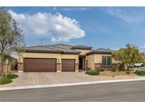 Charming single story home with a three car garage and a beautifully landscaped front yard at 5234 Savannah Rose St, Las Vegas, NV 89149
