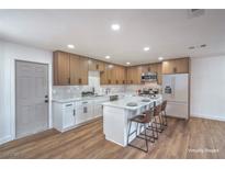 Modern kitchen boasts stainless appliances, center island with bar seating, and ample cabinet space at 5279 Consul Ave, Las Vegas, NV 89142