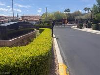 Gated community entrance with lush green landscaping and well-maintained streets offers secure and upscale living at 530 Calahonda Ct, Las Vegas, NV 89138