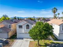 Charming two-story home featuring an attached garage, mountain views and mature trees at 5984 Emerald Canyon Dr, Las Vegas, NV 89142
