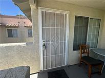Welcoming entryway featuring a secure metal security door and a quaint seating area next to a bright window at 6804 Elm Creek Dr # 202, Las Vegas, NV 89108
