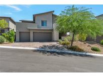 Contemporary two-story home featuring a three-car garage, xeriscaped yard and mature shade tree at 754 Tallgrass St, Las Vegas, NV 89138