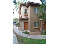 Charming two-story home with neutral stucco, a terracotta roof, and a tidy, desert-style front yard at 7701 W Robindale Rd # 259, Las Vegas, NV 89113