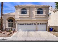 Charming two-story home featuring a tile roof and a two-car garage, providing curb appeal and convenient parking at 8116 Kokoma Dr, Las Vegas, NV 89128
