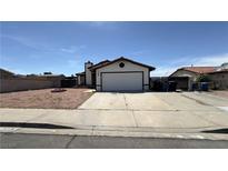 Charming single-story home featuring a two-car garage and low-maintenance desert landscaping at 1003 Palo Verde Dr, Henderson, NV 89015