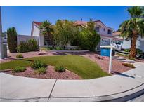 Beautiful two-story home boasts a landscaped front yard with palm trees and lush greenery at 185 Camrose St, Henderson, NV 89074