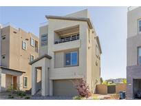 Contemporary two-story home with balcony, neutral stucco, well-kept front yard, and convenient attached two-car garage at 2151 Noble Perch St, Las Vegas, NV 89138