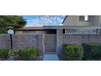 Charming front entrance with brick wall, gate, and manicured bushes at 2216 Short Pine Dr, Las Vegas, NV 89108