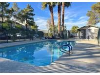 Community pool with palm trees, providing a refreshing and relaxing outdoor space at 2480 Old Forge Ln # 74, Las Vegas, NV 89121