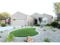 Charming one-story home featuring a well-manicured front yard with gravel landscaping and a touch of artificial turf at 2623 Red Planet St, Henderson, NV 89044