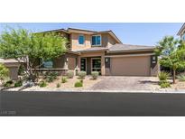 Beautiful two-story home featuring a three-car garage and well-manicured landscaping at 2680 Nevada Agave Ln, Las Vegas, NV 89138