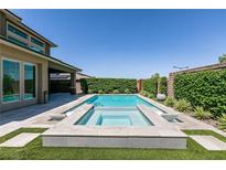 Backyard features a rectangular pool, integrated spa, and lush landscaping at 2680 Nevada Agave Ln, Las Vegas, NV 89138