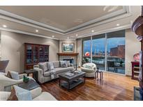 Elegant living room featuring hardwood floors, fireplace, and floor-to-ceiling windows with stunning city views at 2877 Paradise Rd # 2602, Las Vegas, NV 89109