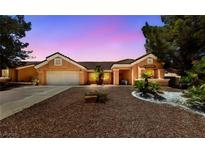 Charming single-story home featuring a low-maintenance desert landscape and a two-car garage at 2925 Lotus Hill Dr, Las Vegas, NV 89134