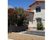 Two-story home featuring desert landscaping, a terracotta roof, and a dedicated parking spot in front at 3464 Twilight Star Dr, Las Vegas, NV 89117