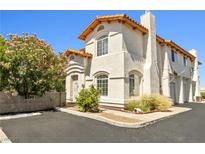 Charming stucco home featuring a red tile roof, arched windows, and desert landscaping at 3464 Twilight Star Dr, Las Vegas, NV 89117