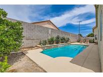 Private backyard pool with a soothing water feature provides relaxation and enjoyment at 3539 Barrel Bronco Ct, North Las Vegas, NV 89032