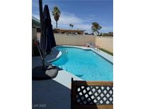 A private outdoor pool in a fenced backyard offers a cool retreat on a sunny day at 3854 Chutney St, Las Vegas, NV 89121